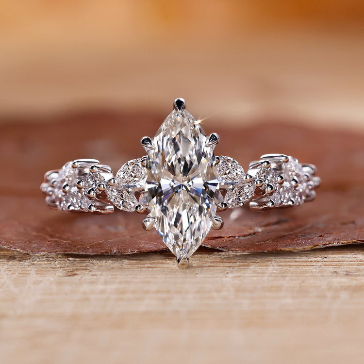 Marquise center diamond ring with zigzag pave set band in white gold.