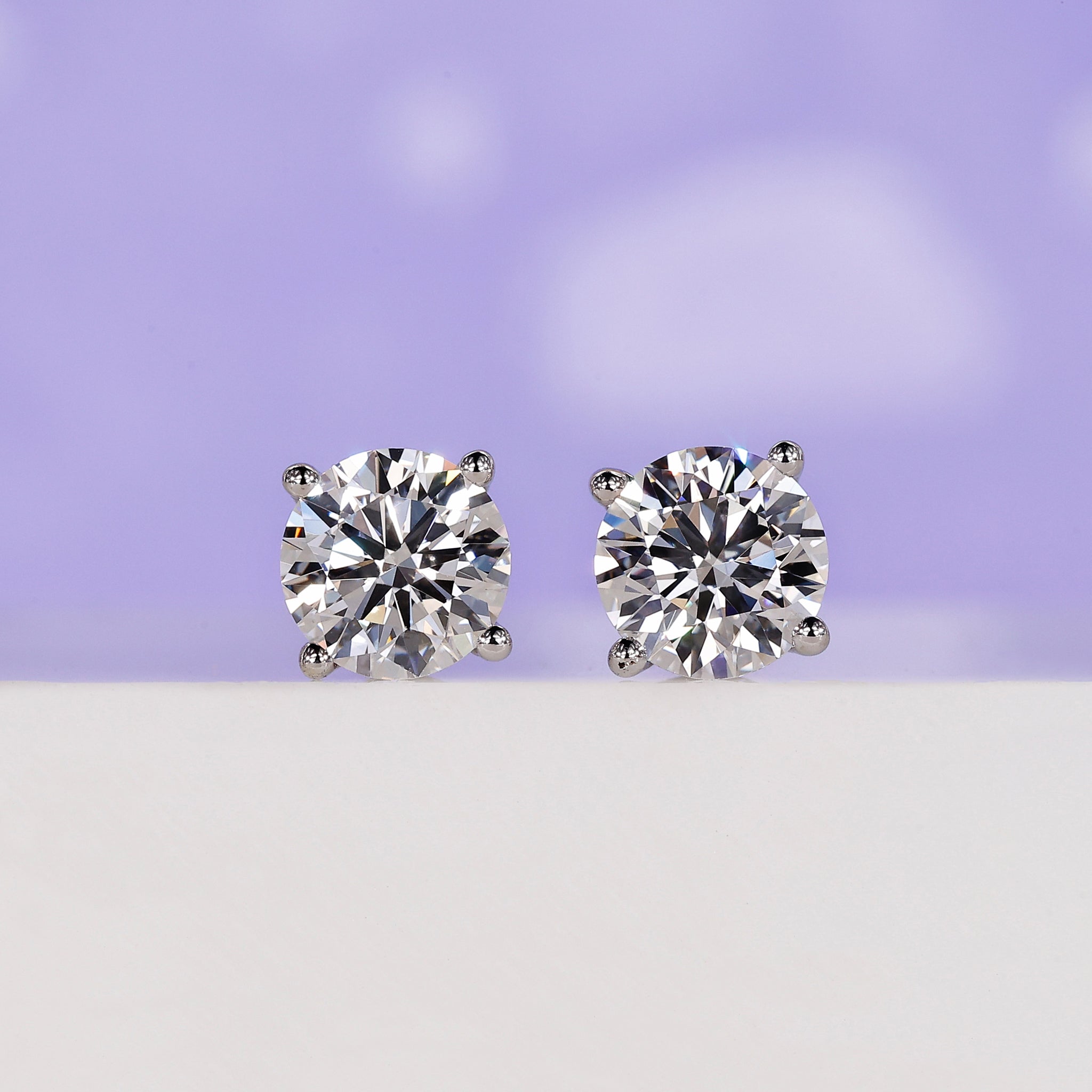 1.50 carat round diamond stud earrings.