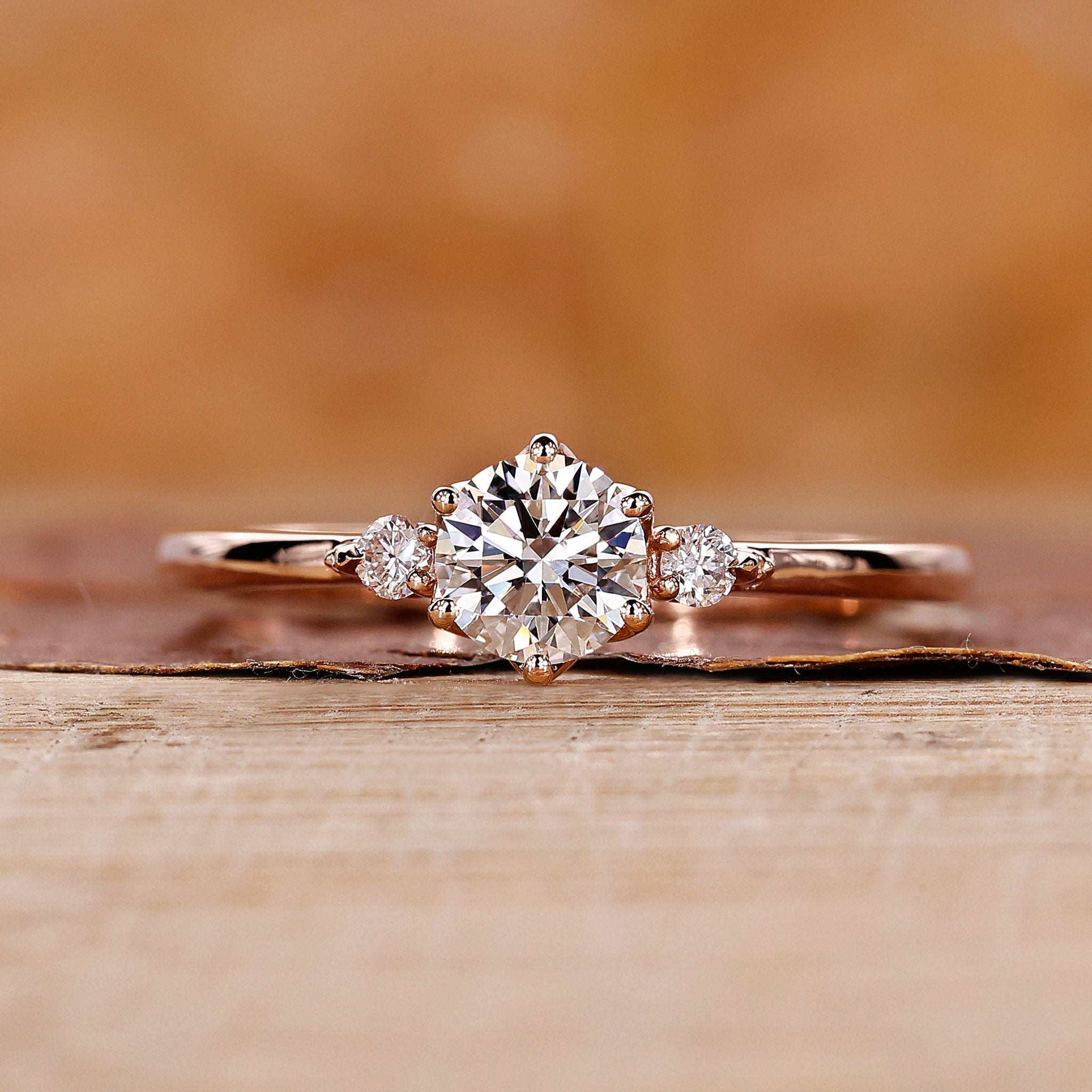 Three stone engagement ring made using rose gold ring.