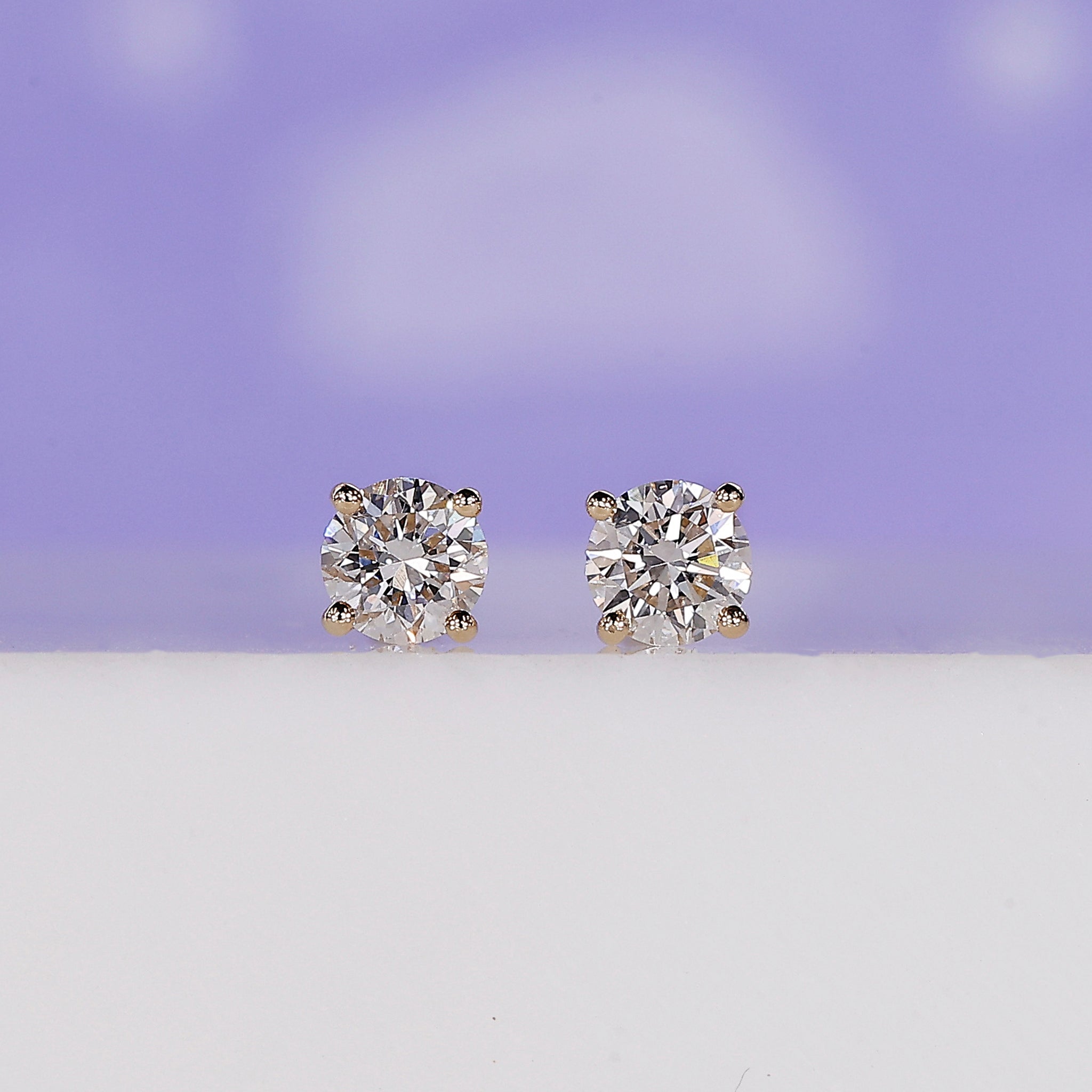 Yellow gold round diamond stud earrings.