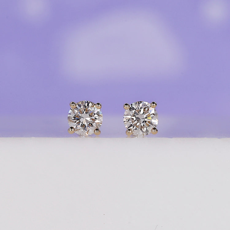 Yellow gold round diamond stud earrings.