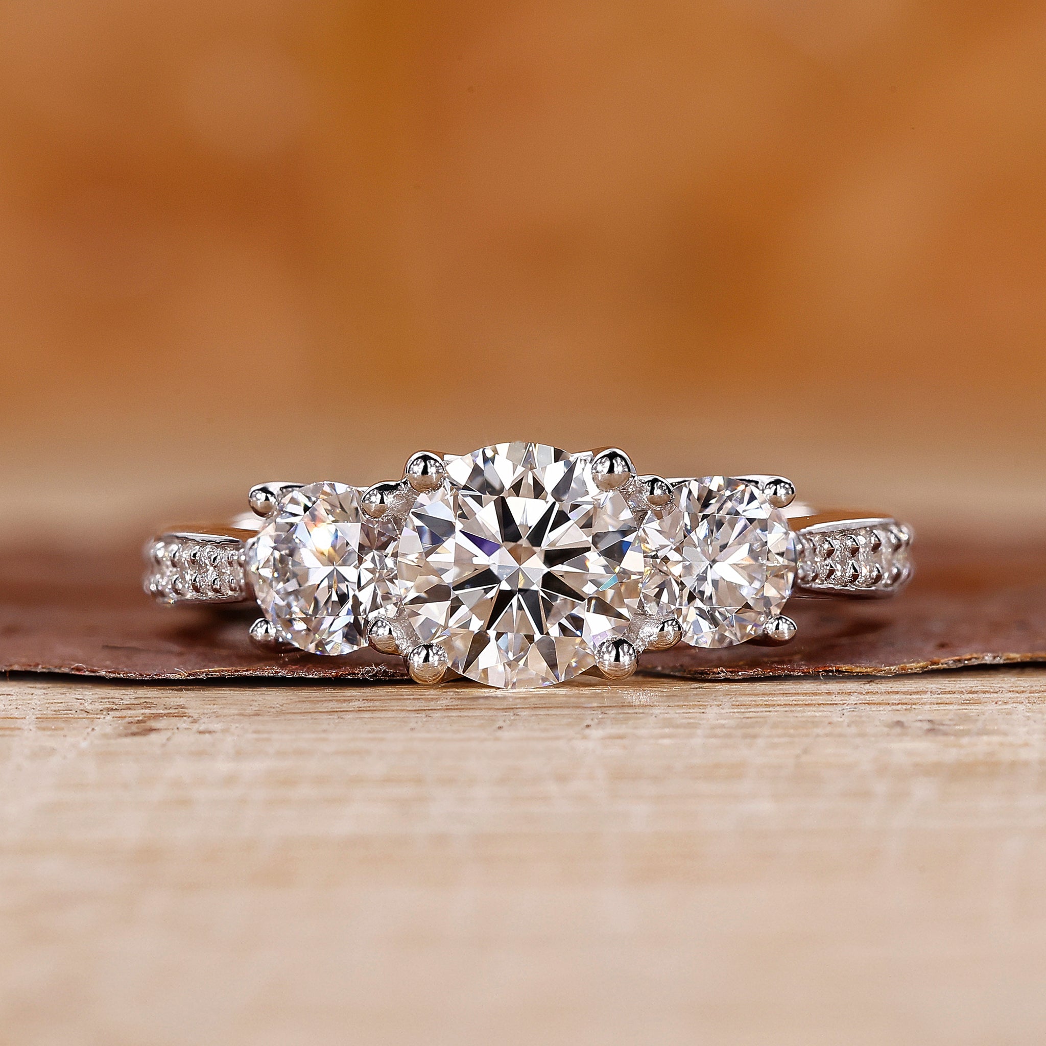 Three diamond engagement ring with tapered pave set in white gold.