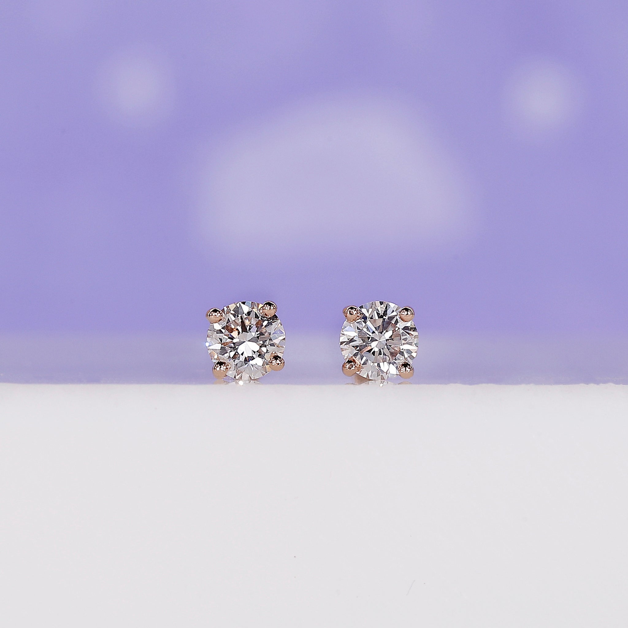 Rose gold diamond stud earrings with screw back.