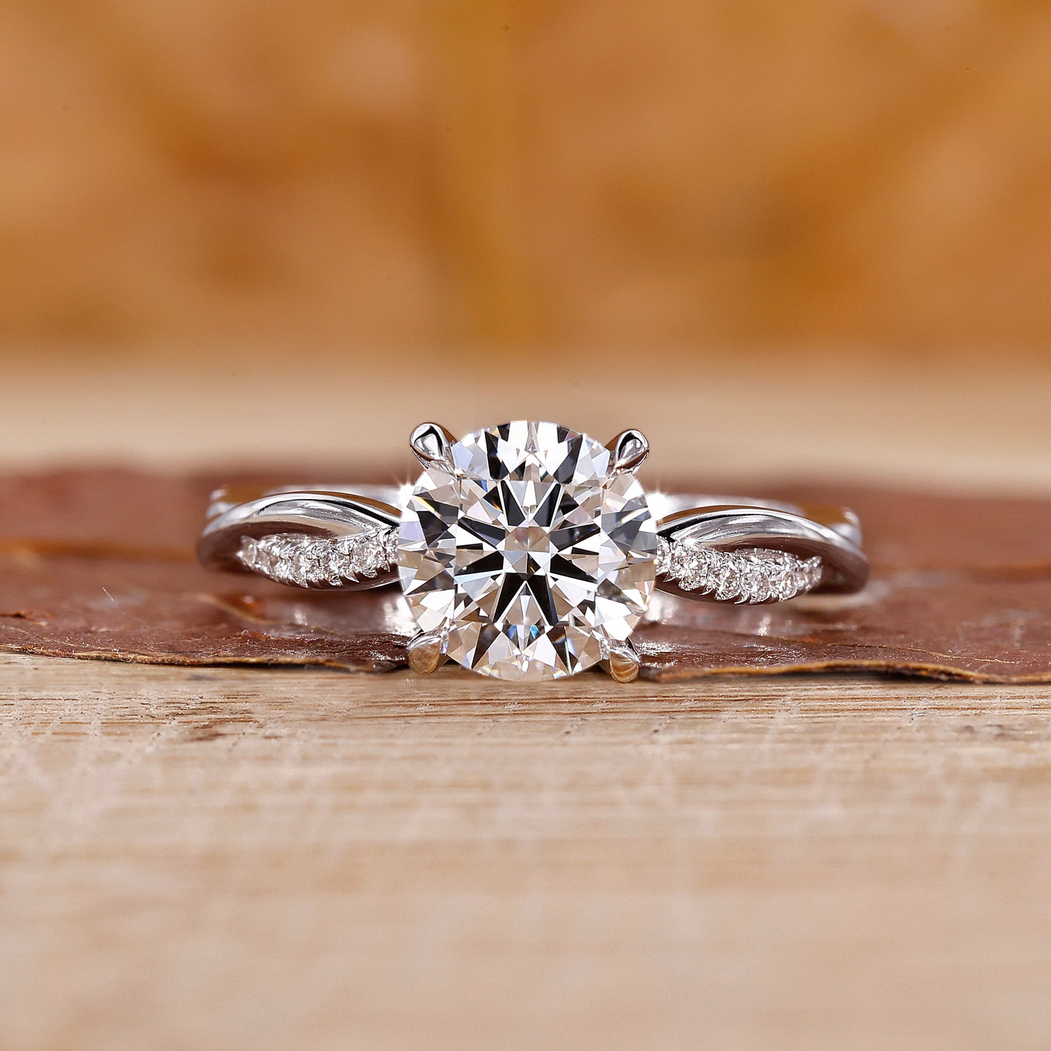 Twisted band engagement ring with round cut diamond in white gold.