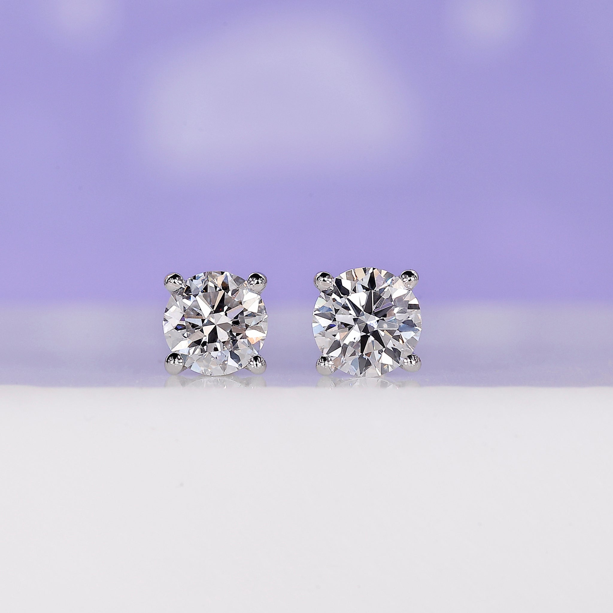 Diamond stud earrings crafted in white gold with round cut stones.