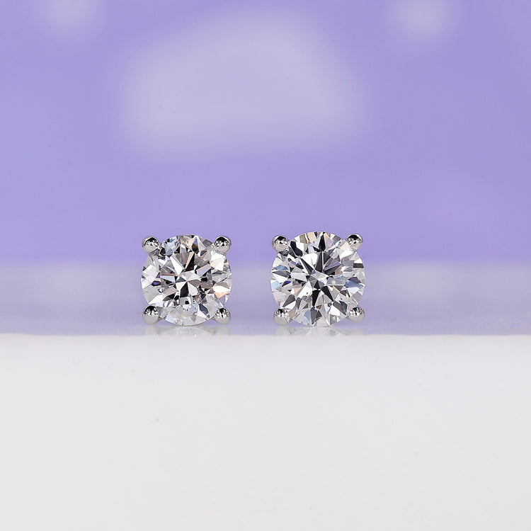 Diamond stud earrings crafted in white gold with round cut stones.