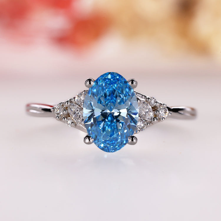 Blue oval diamond engagement ring in white gold with 4 prong set ring design.