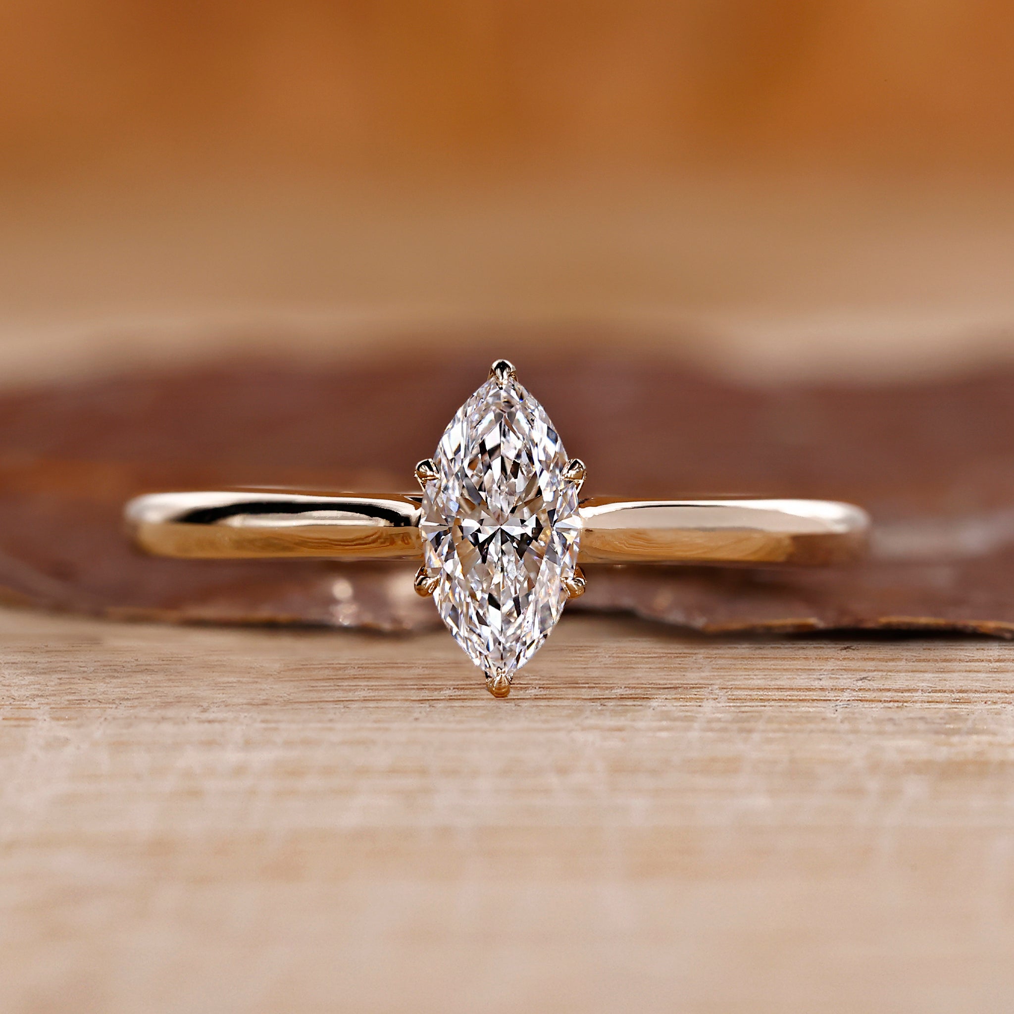 Gold marquise engagement ring with solitaire setting.