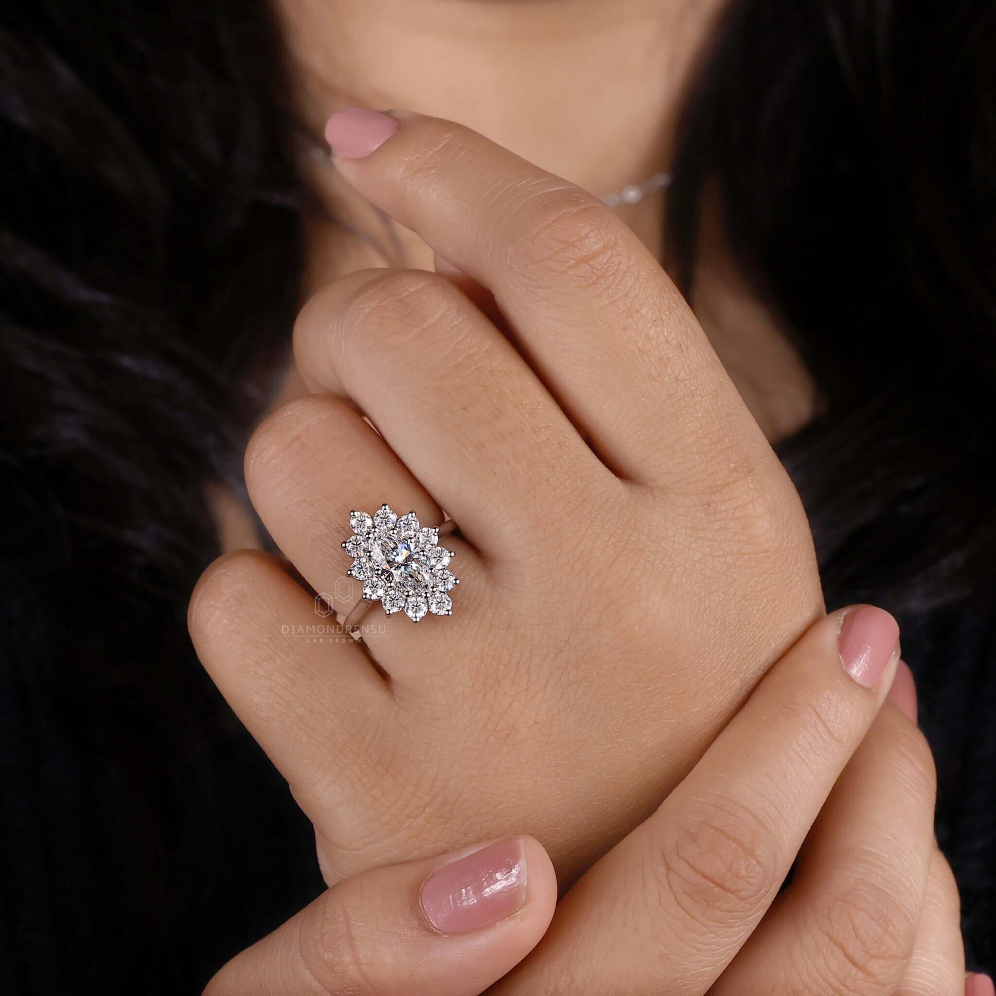 Antique ring featuring a marquise diamond with brilliant cut diamond accents in a unique handmade design.