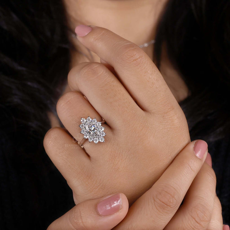 Antique ring featuring a marquise diamond with brilliant cut diamond accents in a unique handmade design.