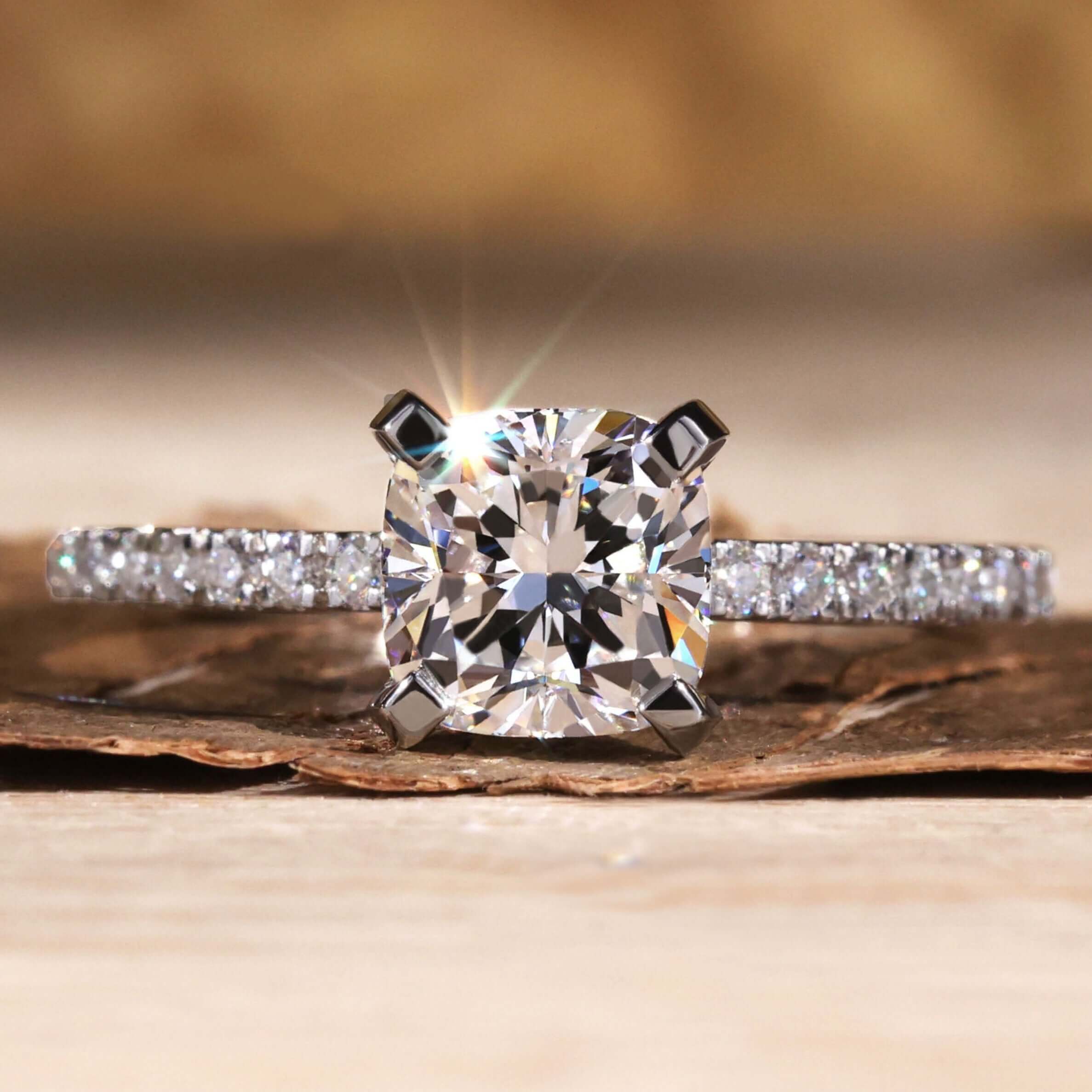 Cushion cut ring with a stunning hidden halo design in a 4-prong setting.