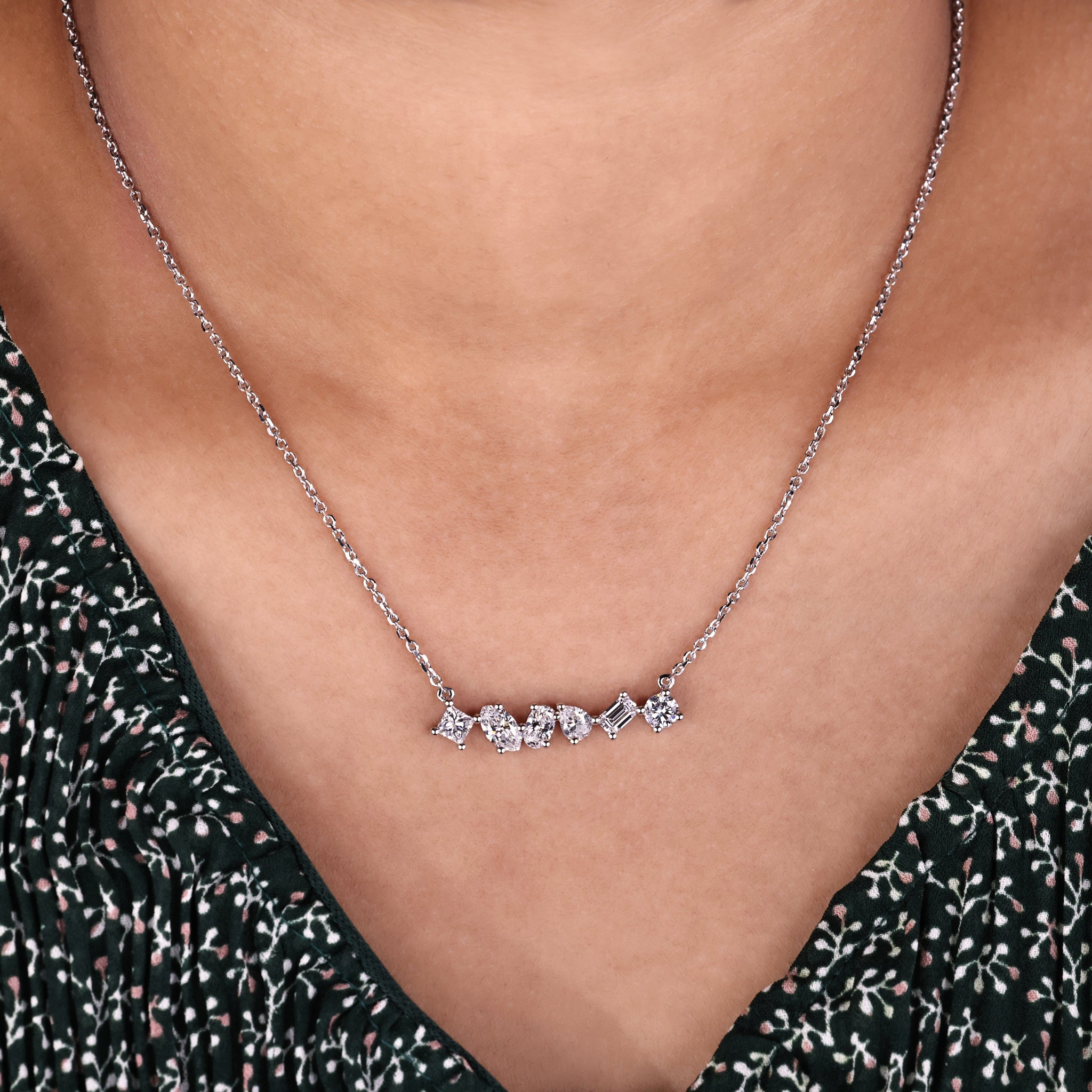 White gold pendant featuring multi shape diamonds in a prong setting.