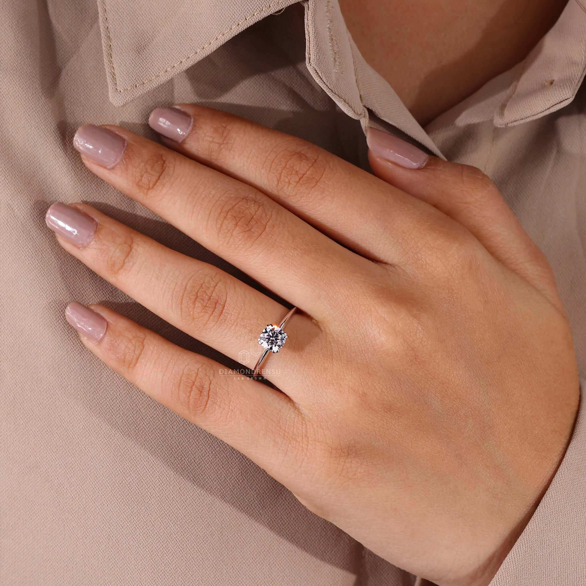 Round ring diamond paired with a claw prong engagement ring for a stunning and elegant finish.