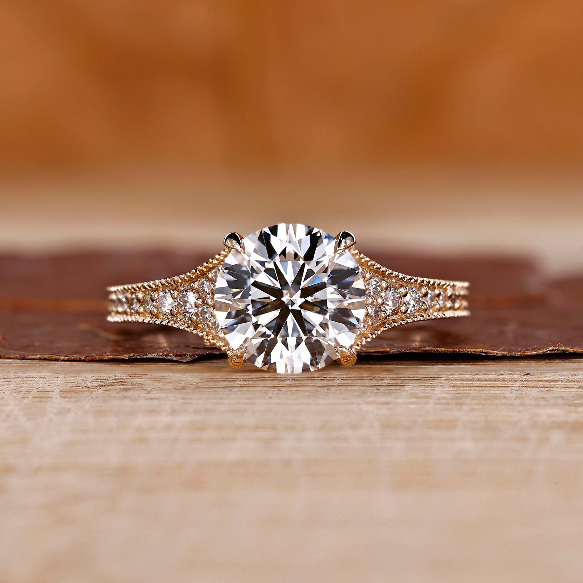 Tapered pave engagement ring with refined detailing.