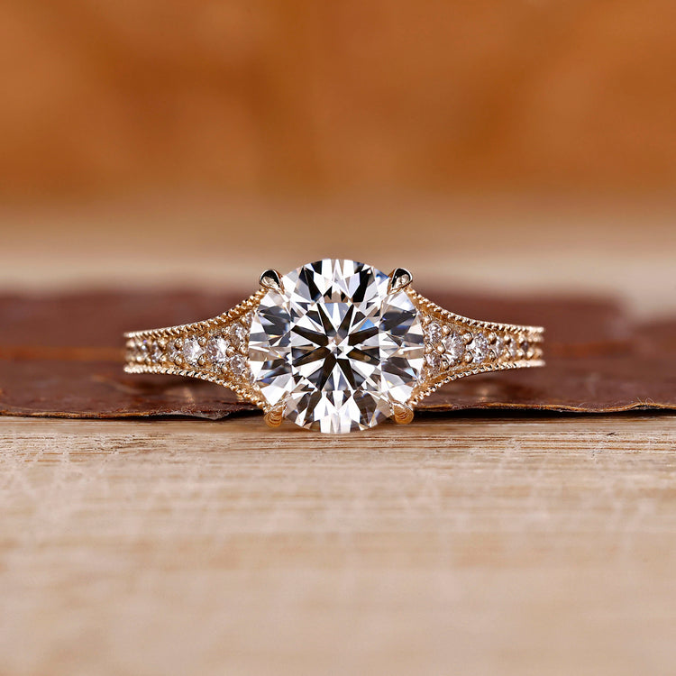 Tapered pave engagement ring with refined detailing.
