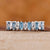 White gold wedding band featuring marquise and baguette diamonds in a half eternity design. White gold wedding band featuring marquise and baguette diamonds in a half eternity design.