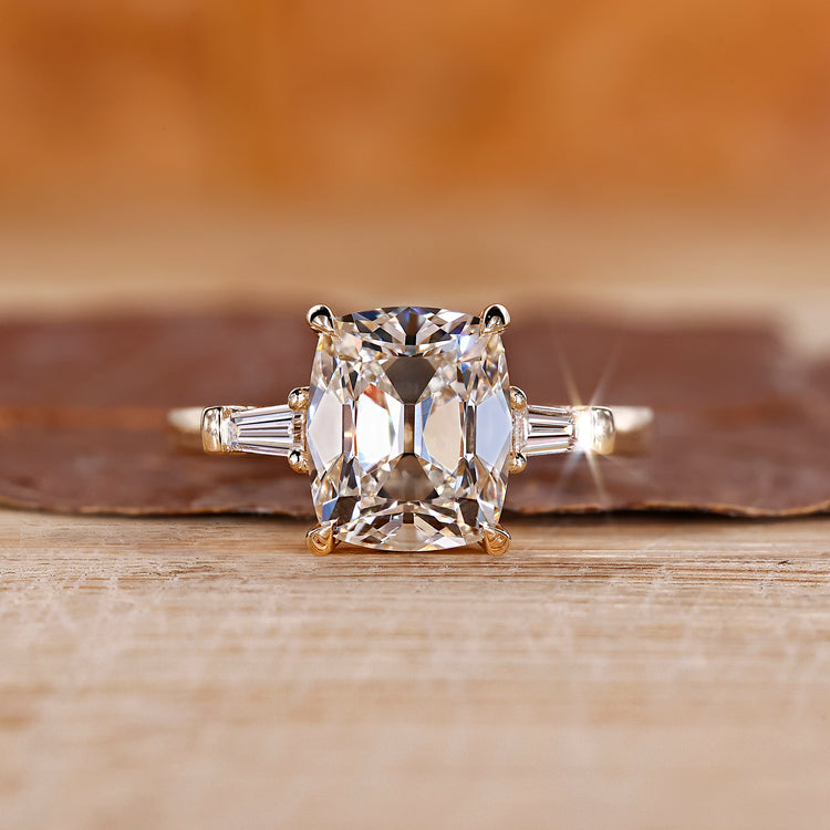Cushion old mine cut ring with tapered baguette sides.