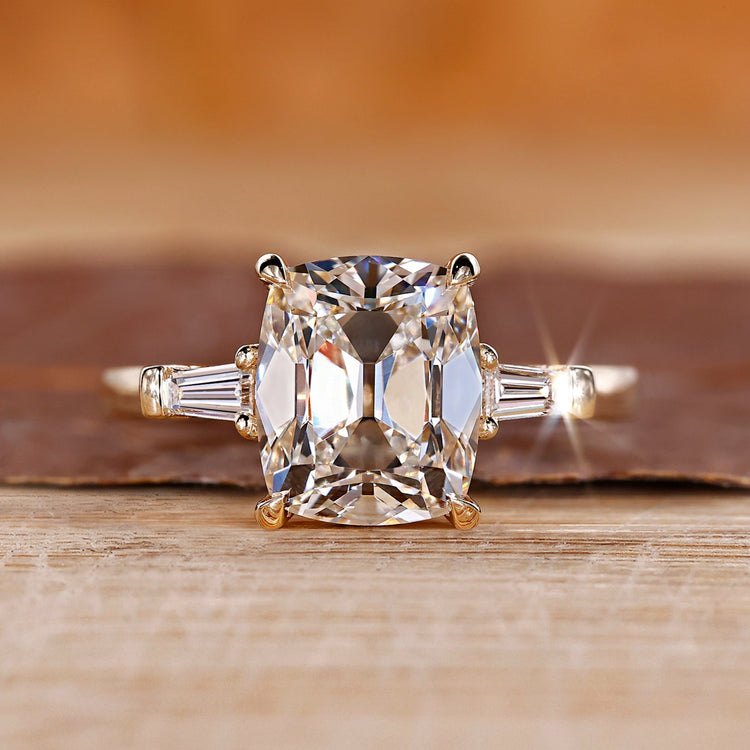 Cushion old mine cut ring with tapered baguette sides.