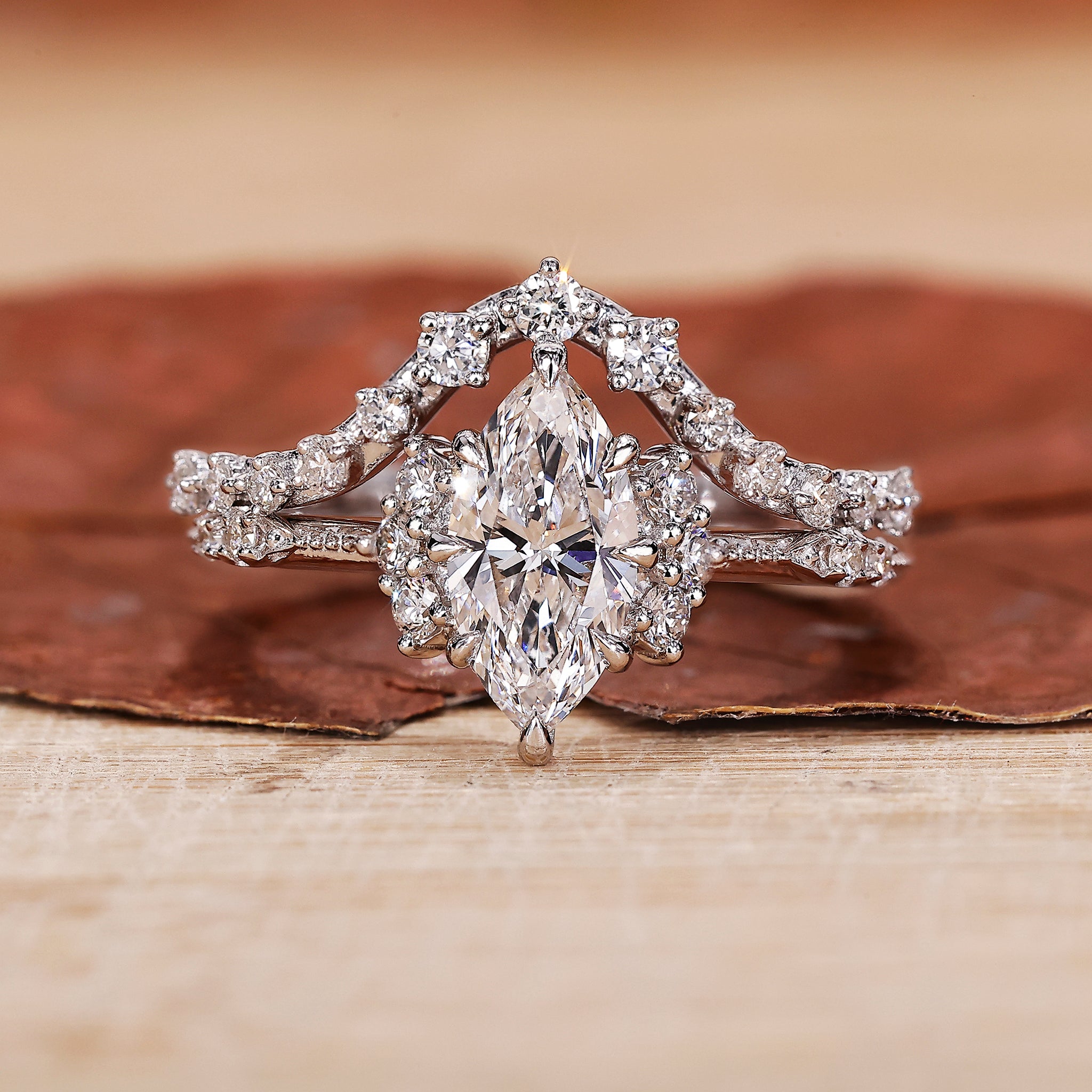 Marquise engagement ring with wedding band and round side stone.