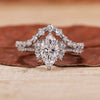 Marquise engagement ring with wedding band and round side stone.
