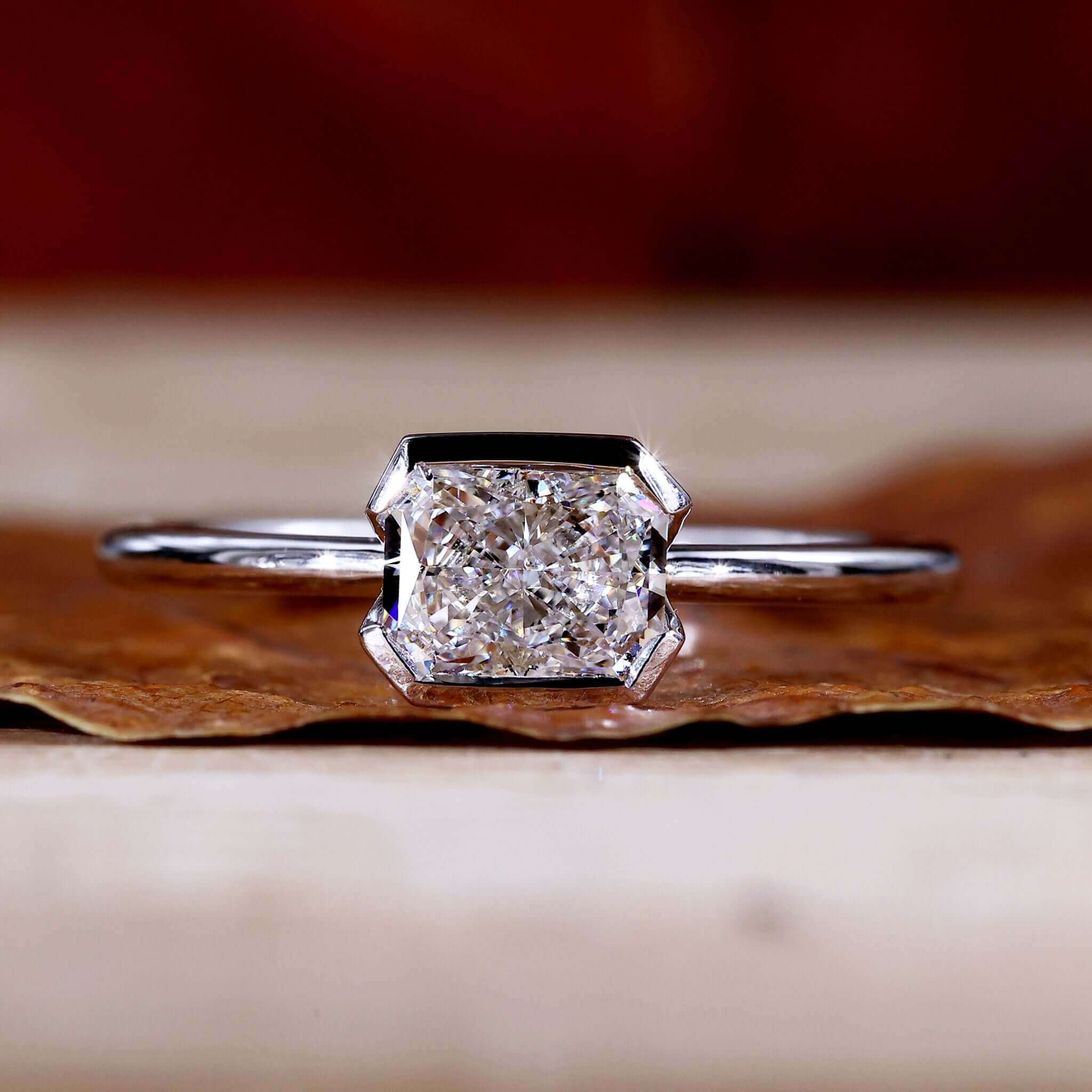 Radiant cut ring with a solitaire diamond in an elegant East to West setting for a modern look.