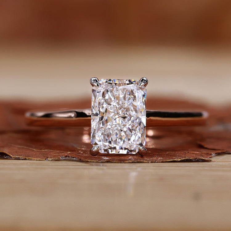 Radiant cut diamond ring with 4 claw setting.