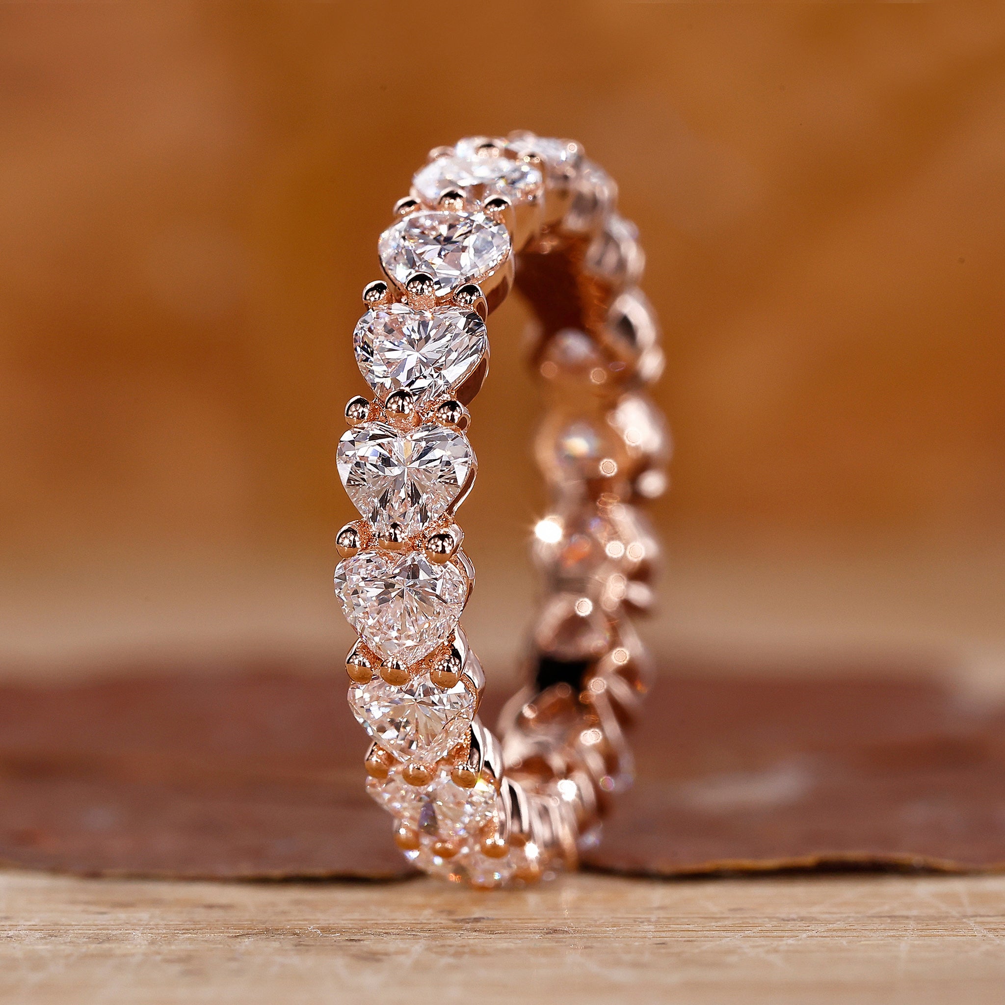 Heart shaped diamond wedding band in rose gold.