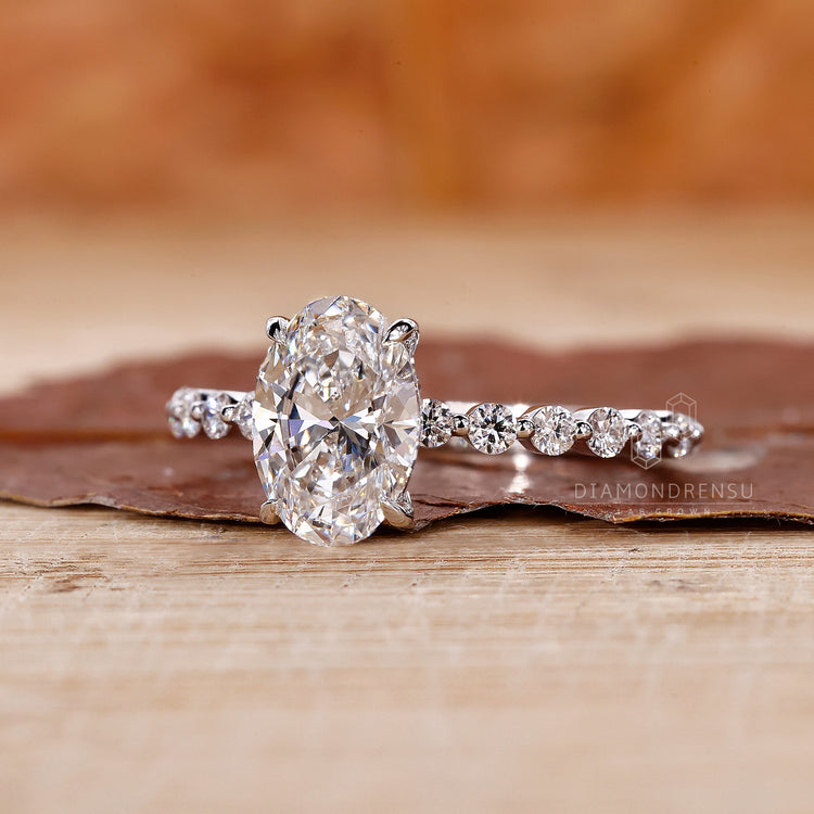 White gold engagement ring styled as oval diamond engagement ring.
