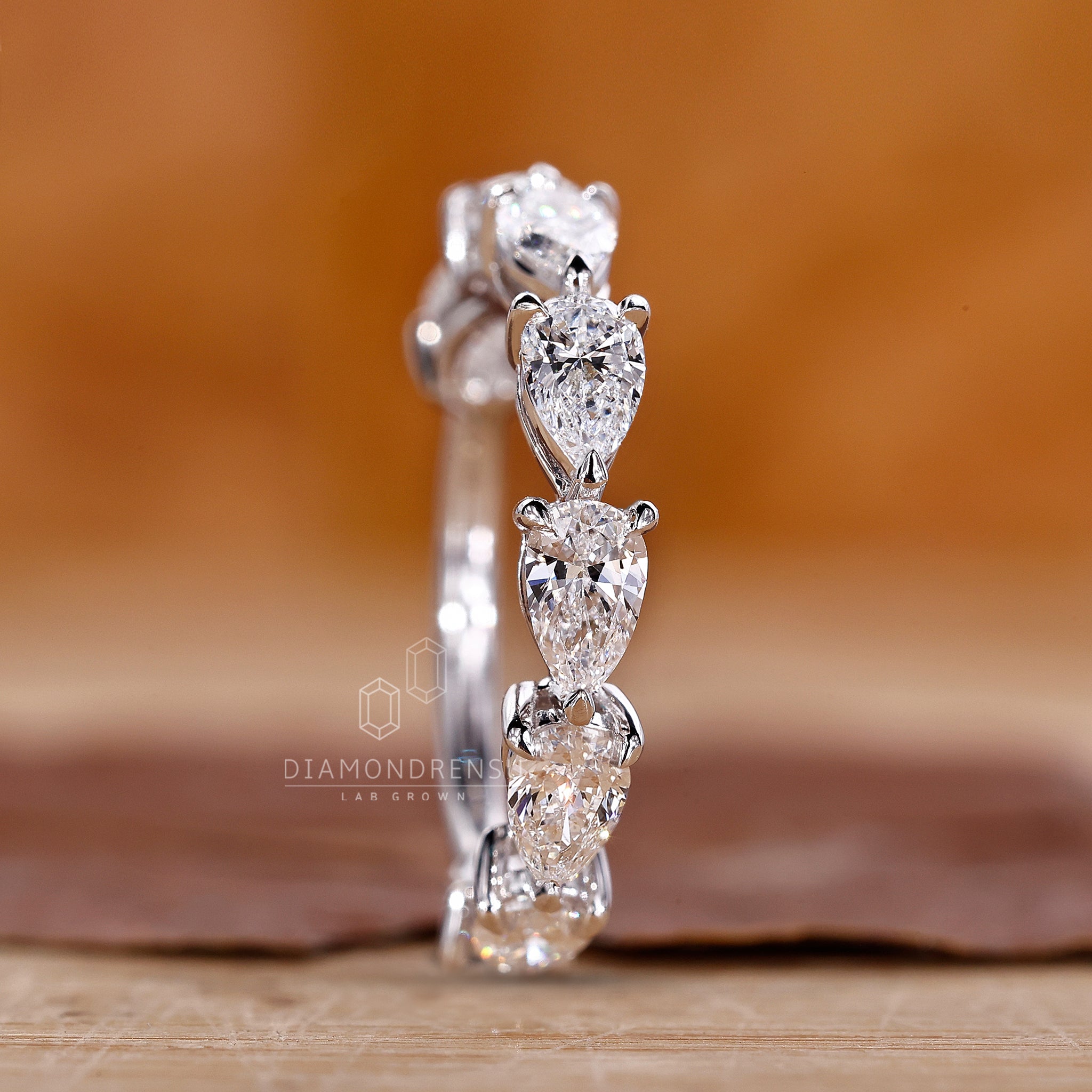 Lab grown pear diamond wedding band.