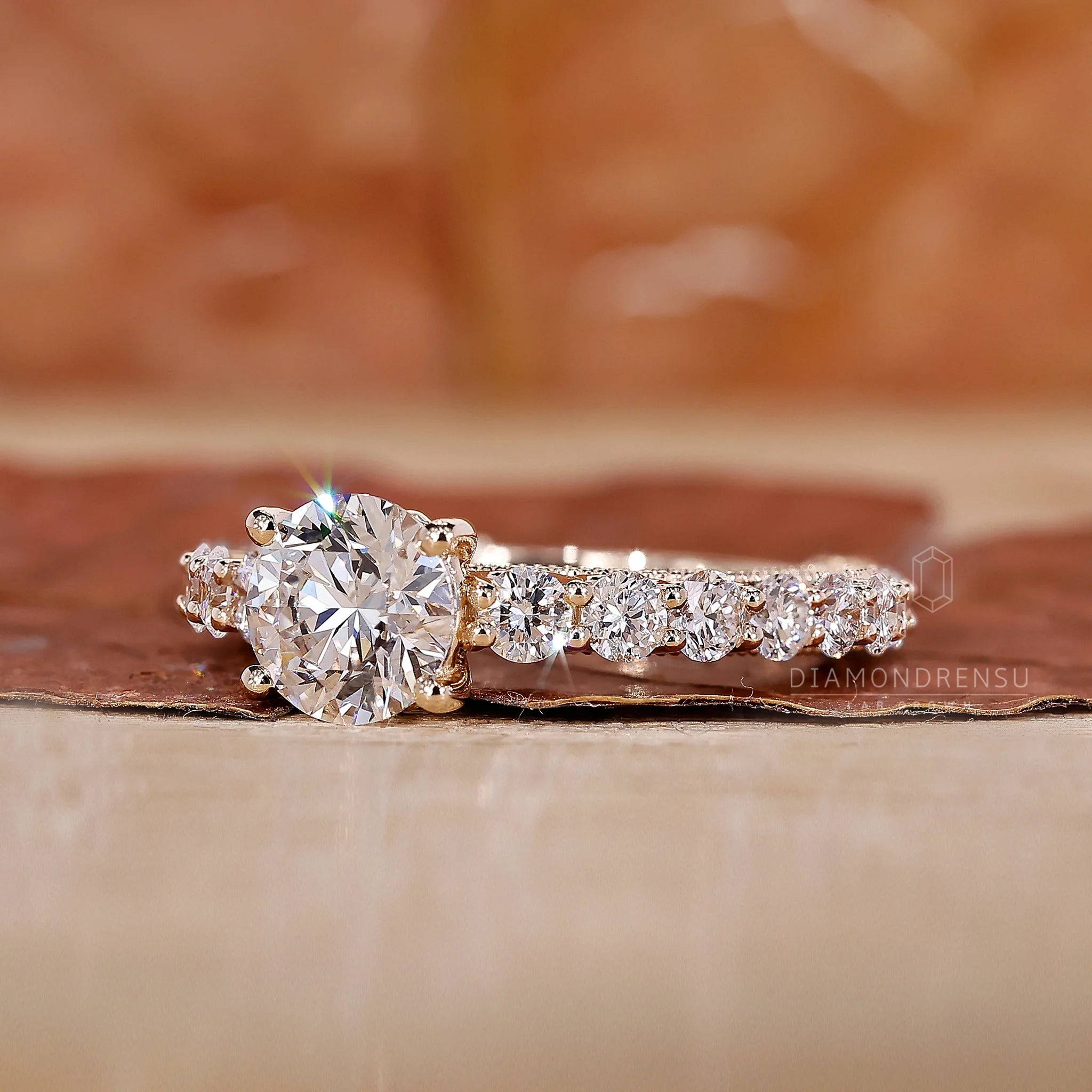 Yellow gold ring featuring a pave setting and milgrain detail.