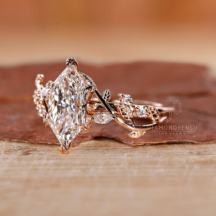 Nature Inspired Diamond Ring with marquise and round side stones.