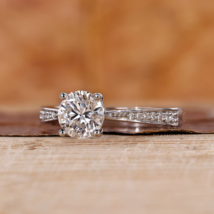 4 prong setting holds diamond in white gold ring.