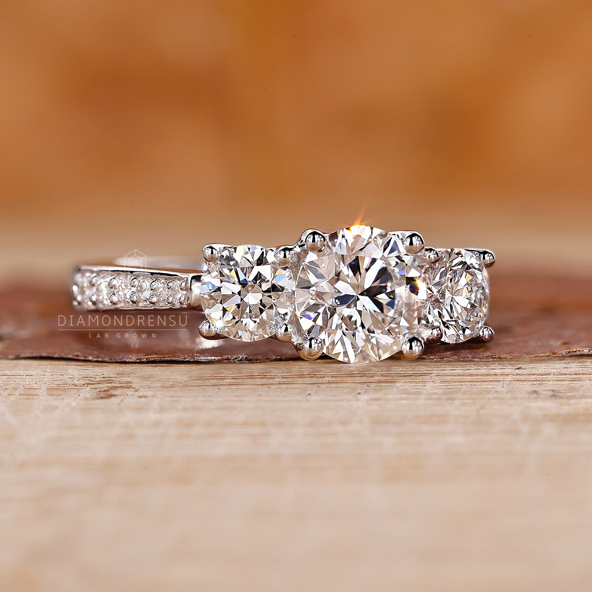 Proposal engagement ring with three round diamonds in white gold.
