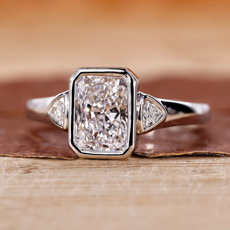 3 stone diamond ring features a radiant engagement ring design.