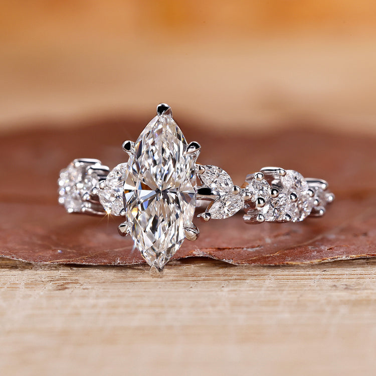 Custom engagement ring with marquise and round side diamond ring design.