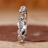 Bezel set wedding band crafted in white gold with marquise and round diamonds.