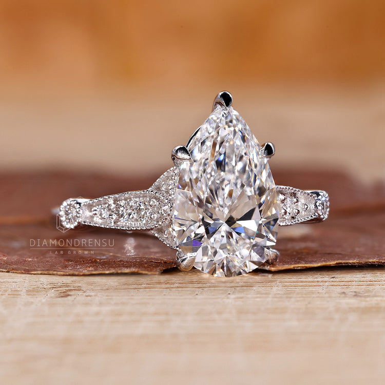 Proposal engagement ring with pear diamond and perong setting design.