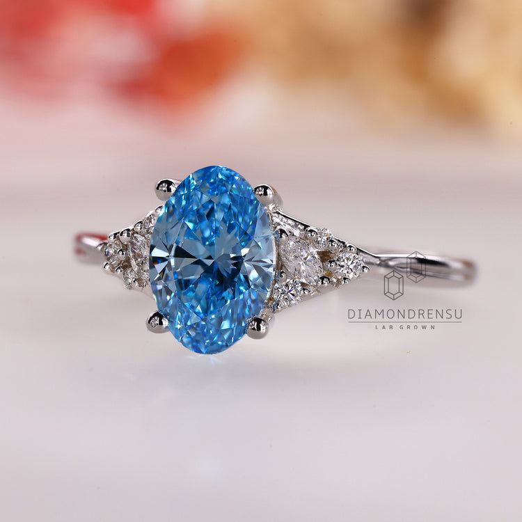 Custom engagement ring with prong set blue oval diamond for UK buyers.