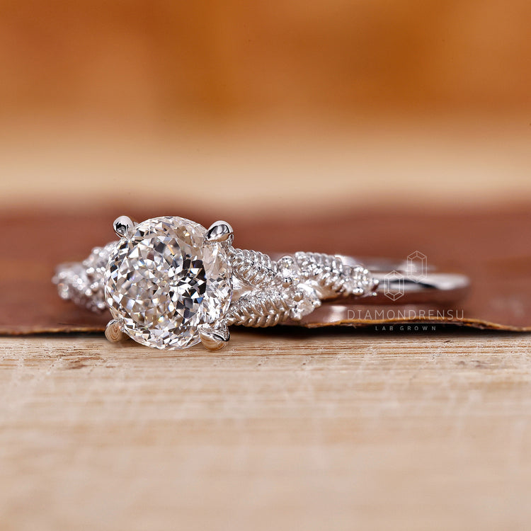 Custom engagement ring with Portuguese cut and round side diamonds.