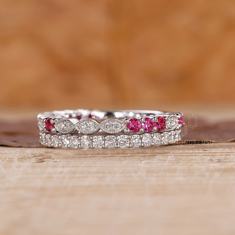 Marquise shape outline band with ruby and diamond accents.