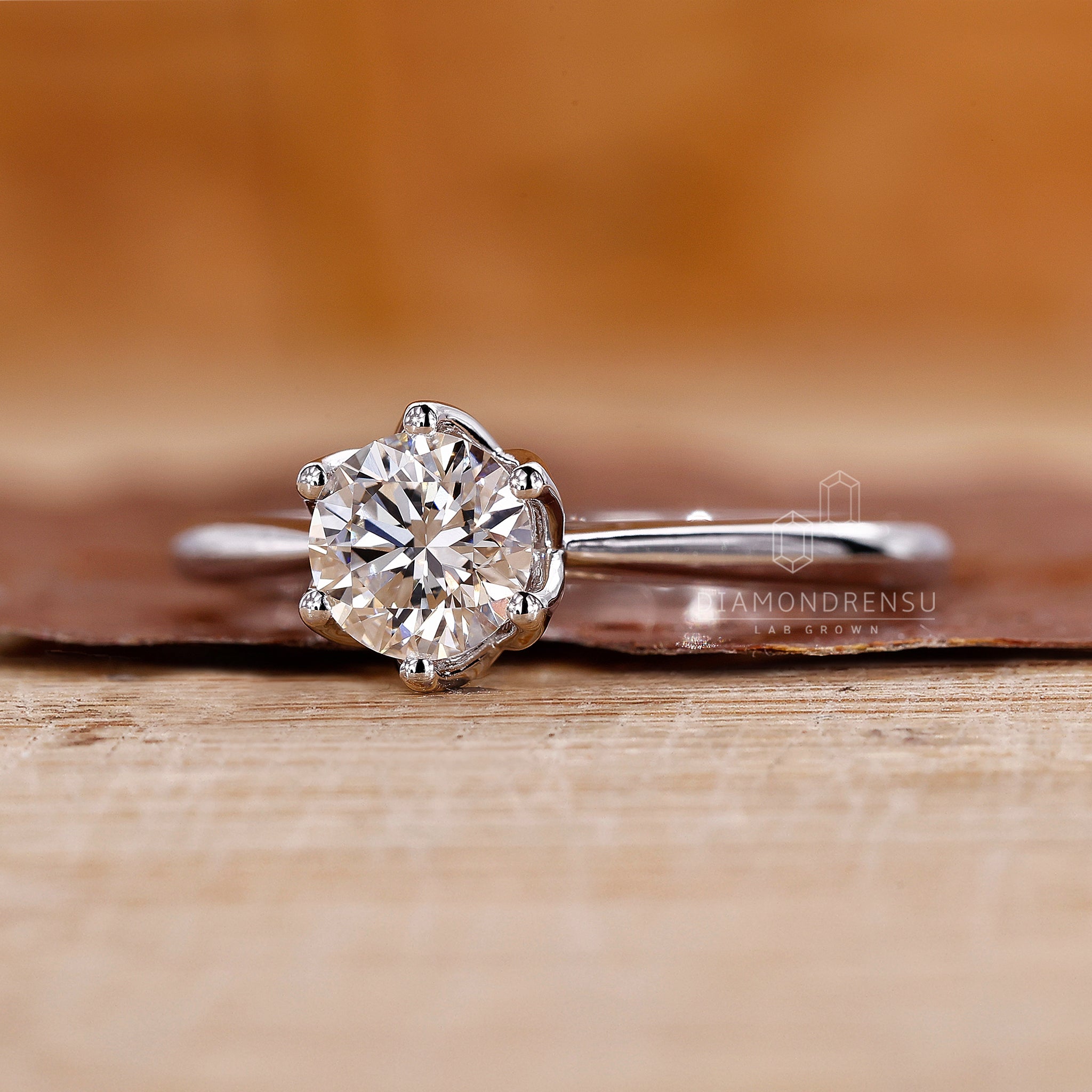 Custom diamond ring with prong setting and tulip style detail.