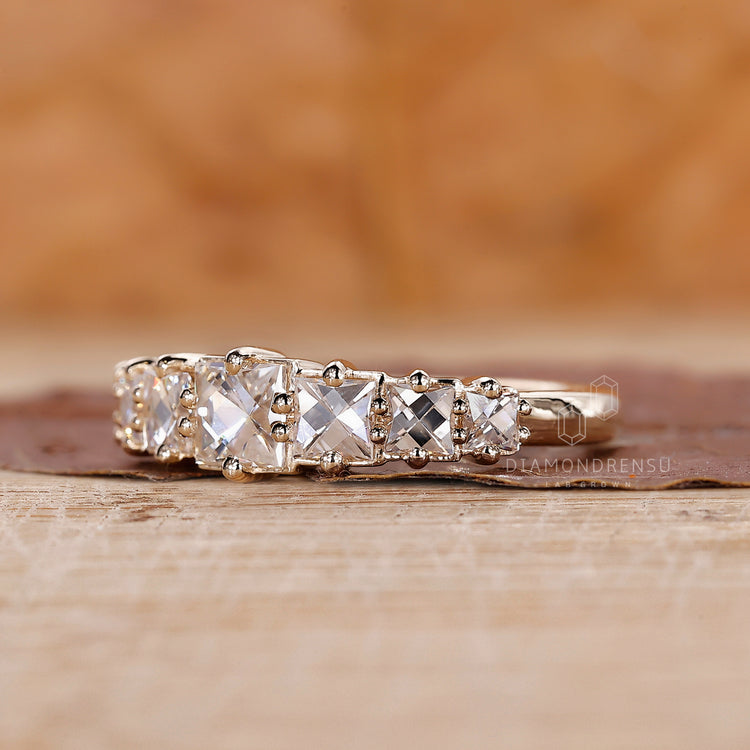 Prong set wedding band with French cut diamonds for a modern look.