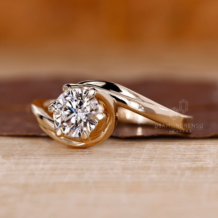 Yellow gold engagement ring with bypass design.
