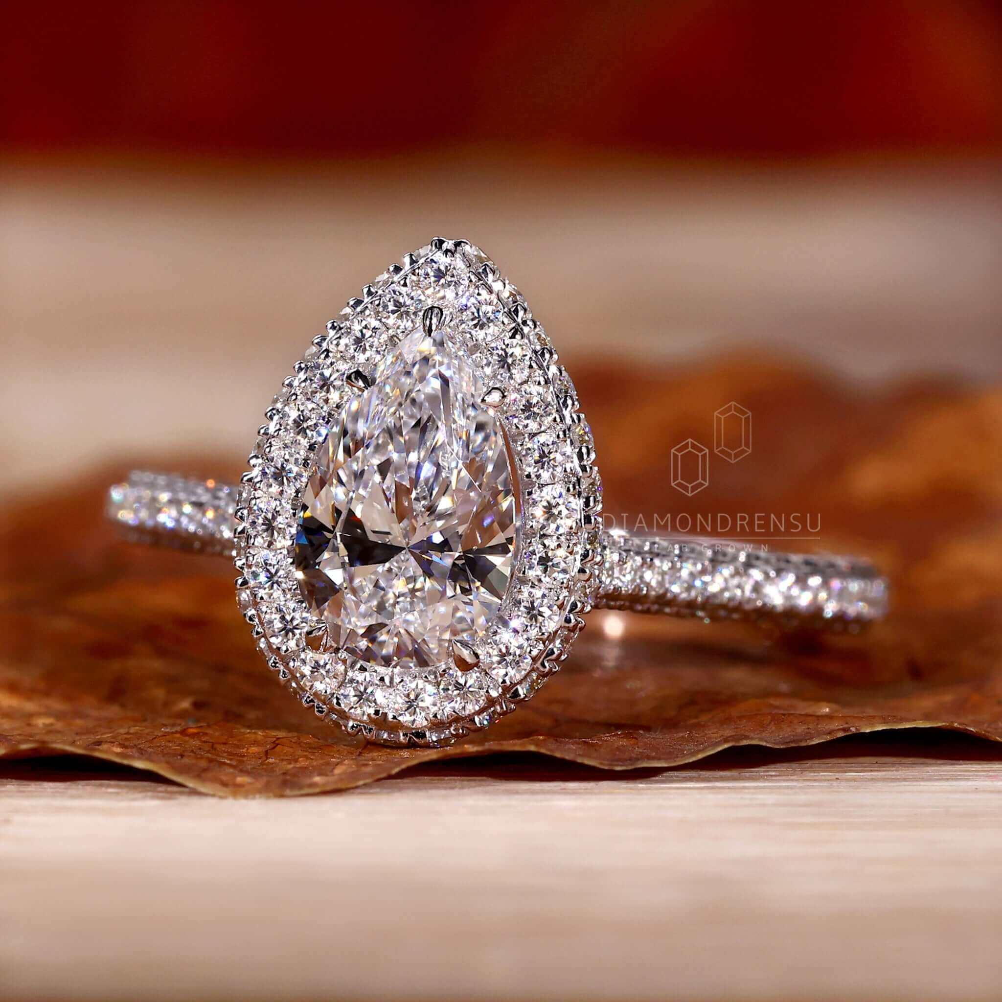 Pear halo ring setting combined with three row pave ring for a luxurious finish.