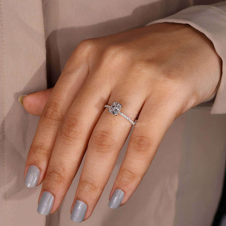 Claw prong setting with a hidden halo ring for modern brides.