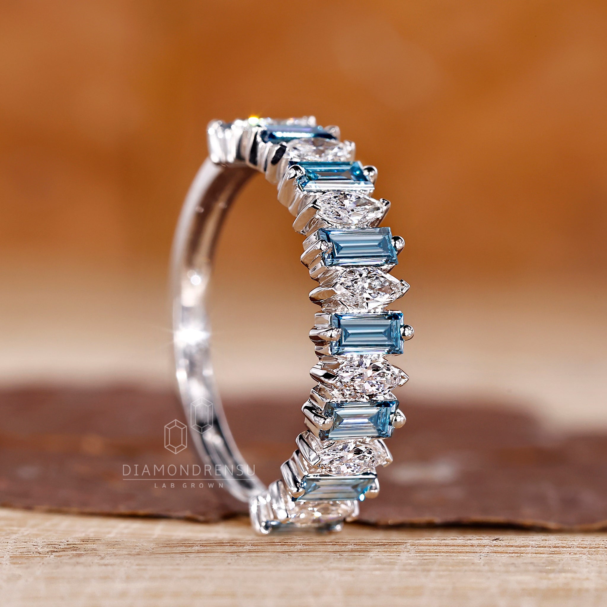 Prong set white gold band with mixed marquise and baguette diamonds.