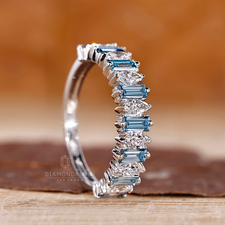 Prong set white gold band with mixed marquise and baguette diamonds.