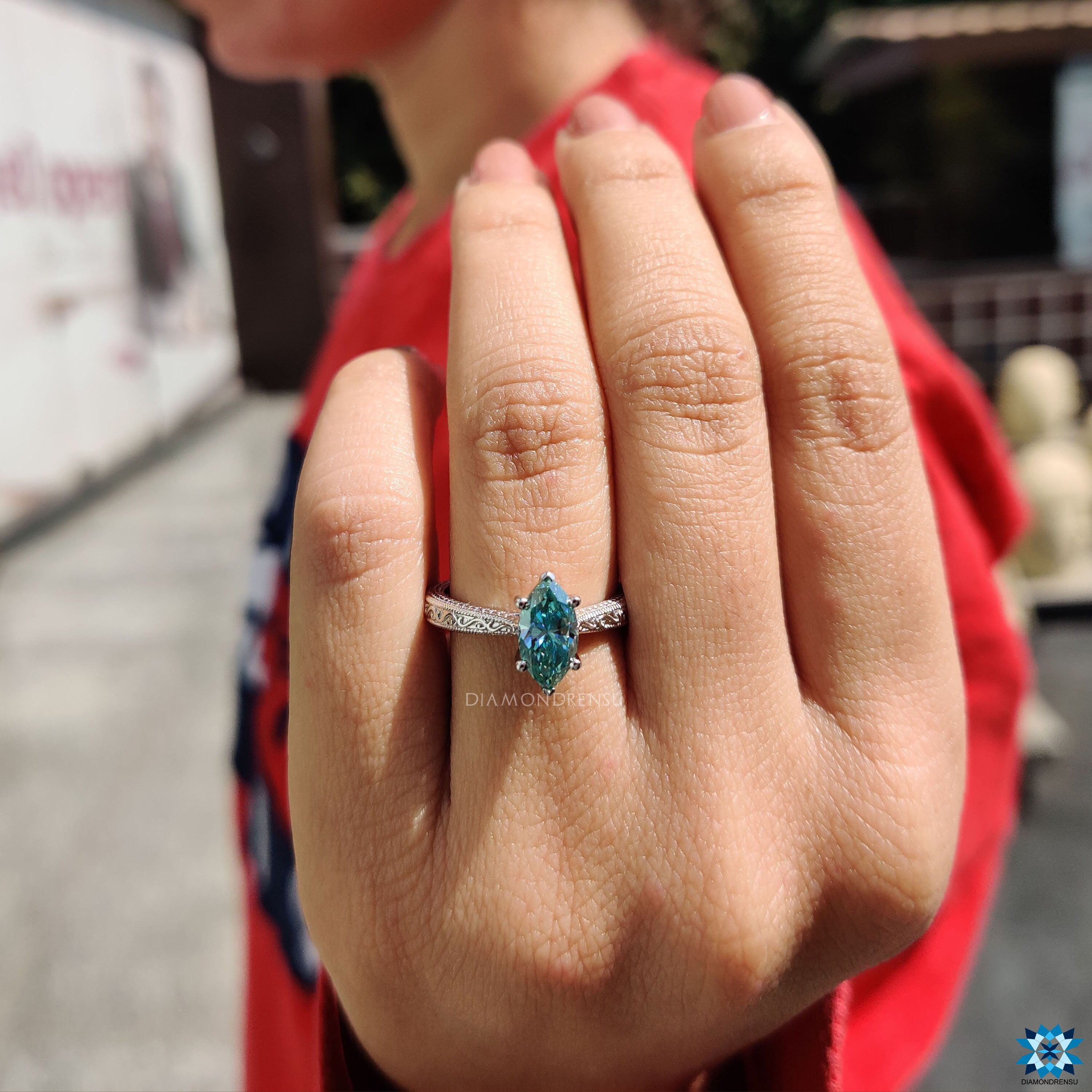 Handmade jewelry marquise engagement ring with round prongs and cyan gemstone.