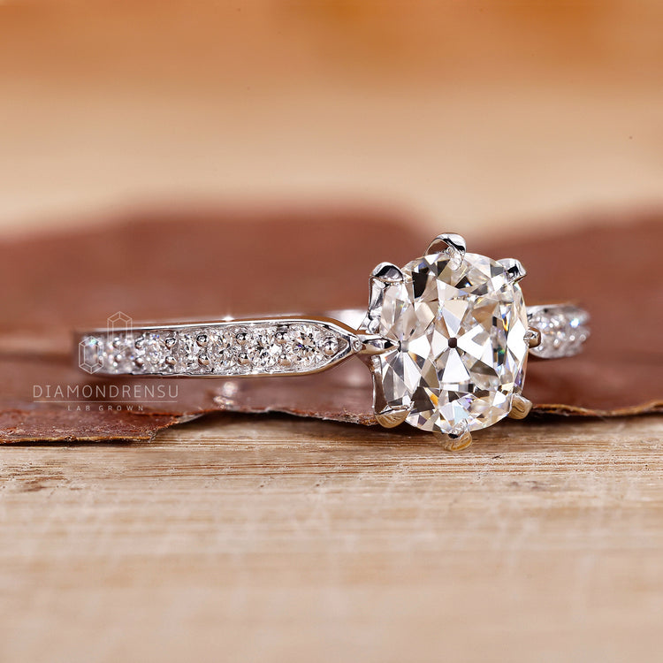 UK engagement ring featuring old mine cut cushion and prong ring setting.
