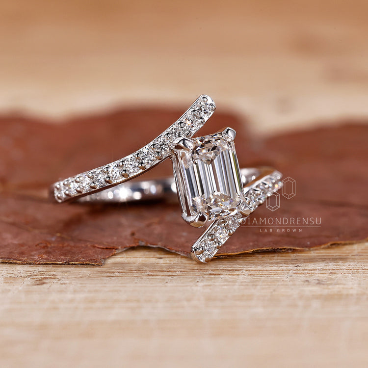 Lab grown diamond ring with custom emerald shape and prong setting.
